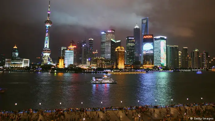 SHANGHAI, CHINA - JULY 15: A sightseeing ship on the Huangpu River against the night skyline of Pudongs Lujiazui Financial District prior to the start of the 14th FINA World Championships on July 15, 2011 in Shanghai, China. (Photo by Feng Li/Getty Images)