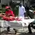 Pakistani volunteers carry injured blast victims to a hospital following a bomb explosion in Karachi on May 11, 2013. A Taliban bomb attack targeting an election candidate killed at least 11 people and wounded 36 others in Pakistan's financial hub of Karachi as polls got under way, a doctor said. The bomb targeted a candidate seeking election to the Sindh provincial assembly for the Awami National Party (ANP), the main secular party for ethnic Pashtuns, police said. AFP PHOTO / RIZWAN TABASSUM (Photo credit should read RIZWAN TABASSUM/AFP/Getty Images)