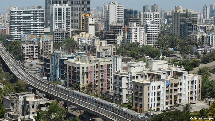 A Mumbai Metro train passes through a residential area during its first official safety trial run in Mumbai (Getty Images)
