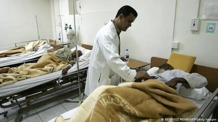 MINA, SAUDI ARABIA: A doctor tends to a wounded Muslim pilgrim at a hospital following a stampede at the eastern entrance of the Jamarat bridge, where the pilgrims stone three pillars symbolizing the devil in the valley of Mina, east of the holy city of Mecca, 12 January 2006. At least 345 Muslim pilgrims were trampled to death as they tripped over luggage in a scramble to hurl pebbles at symbols of Satan during the annual pilgrimage, Saudi officials said. AFP PHOTO/BEHROUZ MEHRI (Photo credit should read BEHROUZ MEHRI/AFP/Getty Images)