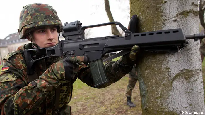 BERLIN - APRIL 14: A young recruit of the Bundeswehr guard of honour practices in basic training with the G36 assault rifle at the Julius Leber barracks on April 14, 2010 in Berlin, Germany. German Defense Minister Karl-Theodor zu Guttenberg and Family Minister Kristina Schroeder are seeking to push through a new law to shorten the current service period of 9 months down to 6, though zu Guttenberg acknowledges the move would likely cost the military an additional EUR 26 million annually. (Photo by Carsten Koall/Getty Images)