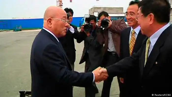 Japanese Cabinet Secretariat Advisor Isao Iijima (L) shakes hands with North Korean officials as he arrives at Pyongyang airport, in this May 14, 2013 screen grab taken by a video from KCNA. Iijima, an adviser to Japanese Prime Minister Shinzo Abe arrived in North Korea on Tuesday in a rare surprise visit to a country with which Japan has no diplomatic ties, but the purpose of the visit was not immediately known. REUTERS/KCNA For Reuters TV (NORTH KOREA - Tags: POLITICS) ATTENTION EDITORS - FOR EDITORIAL USE ONLY. NOT FOR SALE FOR MARKETING OR ADVERTISING CAMPAIGNS. THIS IMAGE HAS BEEN SUPPLIED BY A THIRD PARTY. IT IS DISTRIBUTED, EXACTLY AS RECEIVED BY REUTERS, AS A SERVICE TO CLIENTS. NORTH KOREA OUT. NO COMMERCIAL OR EDITORIAL SALES IN NORTH KOREA. REUTERS IS UNABLE TO INDEPENDENTLY VERIFY THE AUTHENTICITY, CONTENT, LOCATION OR DATE OF THIS IMAGE