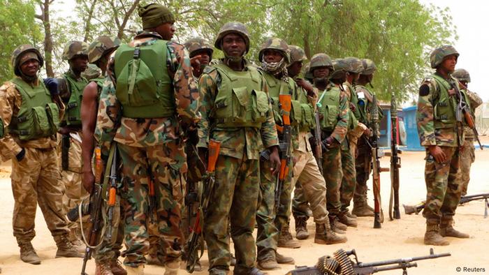 Soldiers stand during a parade in Baga village on the outskirts of Maiduguri, in the north-eastern state of Borno May 13, 2013. To match Insight NIGERIA-ISLAMISTS-INSIGHT/ REUTERS/Tim Cocks (NIGERIA - Tags: MILITARY CIVIL UNREST)