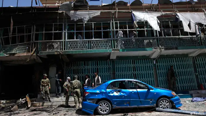 Afghan policemen stand guard at the site of a suicide attack in Kabul May 16, 2013. A suicide bomber in a car targeted two vehicles carrying foreign forces in the Afghan capital Kabul on Thursday, police said, but it was not immediately clear if there were casualties. REUTERS/Mohammad Ismail (AFGHANISTAN - Tags: CIVIL UNREST)