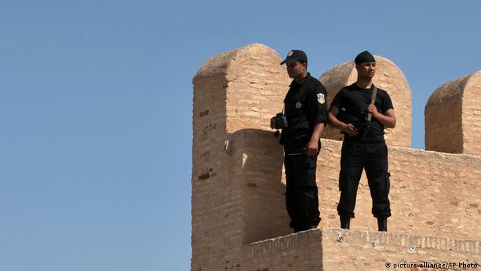 Tunisian security officers stand guard, in the city of Kairouan, where ultraconservative Islamic group, Ansar al-Shariah's, annual conference supposed to be held, Sunday May 19, 2013. A massive Tunisian security presence has surrounded the countrys main religious center of Kairouan and prevented hardline Muslims from holding their annual gathering. Some 11,000 police surrounded the city this weekend and patrolled inside to prevent the conference from taking place because of the threat it represented to security and public order. (AP Photo/ Amine Landoulsi)