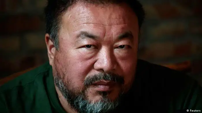 Dissedent Chinese artist Ai Weiwei reacts during a group interview at his studio in Beijing May 22, 2013. Ai made his first foray into the musical world on Wednesday with the release of the top single from his debut album, a song called Dumbass that takes inspiration from his detention in 2011. The video for the heavy metal song, which was directed by Ai with cinematography by acclaimed filmmaker Christopher Doyle, depicts Ai's 81 days in secretive detention in 2011, which sparked an international outcry. REUTERS/Petar Kujundzic (CHINA - Tags: POLITICS SOCIETY)