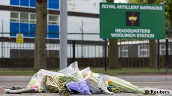 Floral tributes are seen outside the Royal Military Barracks, near the scene where a man was killed in Woolwich, southeast London May 23, 2013. A British soldier was hacked to death on Wednesday by two men shouting Islamic slogans in a south London street, in what Prime Minister David Cameron said appeared to be a terrorist attack. REUTERS/Neil Hall (BRITAIN - Tags: CRIME LAW MILITARY POLITICS SOCIETY)