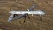 A gray drone aircraft flies against a brown desert backdrop. Photo: Leslie Pratt Photo: Effrain Lopez A gray drone aircraft flies against a brown desert backdrop. Photo: Leslie Pratt Photo: Effrain Lopez