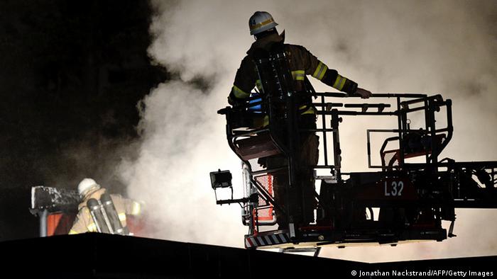Firemen extinguish a blaze at a nursery school in the Stockholm suburb of Kista after youths rioted in several different suburbs around Stockholm (photo via Getty images)