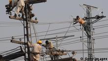 Pakistani technicians work on high voltage power lines in Lahore on January 13, 2011. Pakistan faces a crippling energy crisis, as it is only able to produce about 80 percent of the electricity it needs, causing debilitating blackouts and suffocating industry. AFP PHOTO/ ARIF ALI (Photo credit should read Arif Ali/AFP/Getty Images)