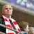 Uli Hoeneß steht mit Bayern-Schal bekleidet auf der Tribüne. Sein Blick ist auf das Spielfeld gerichet. (Foto: Peter Kneffel/dpa)