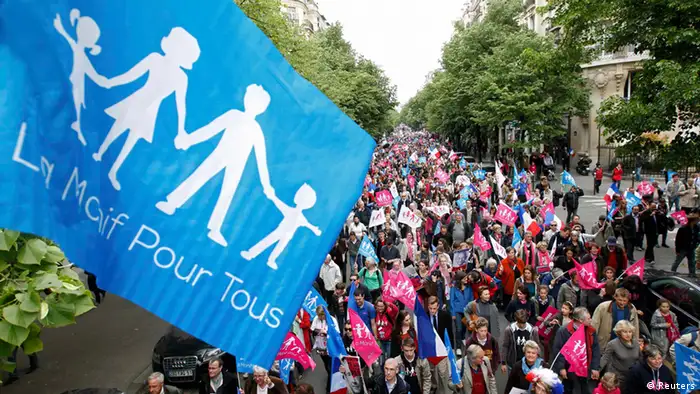 People wave trademark pink, blue and white flags as they attend a protest march called, La Manif pour Tous (Demonstration for All) against France's legalisation of same-sex marriage, in Paris, May 26, 2013. The French parliament on April 23 approved a law allowing same-sex couples to marry and to adopt children, a flagship reform pledge by the French president, which has often sparked violent street protests, and a rise in homophobic attacks. REUTERS/Stephane Mahe (FRANCE - Tags: POLITICS CIVIL UNREST)