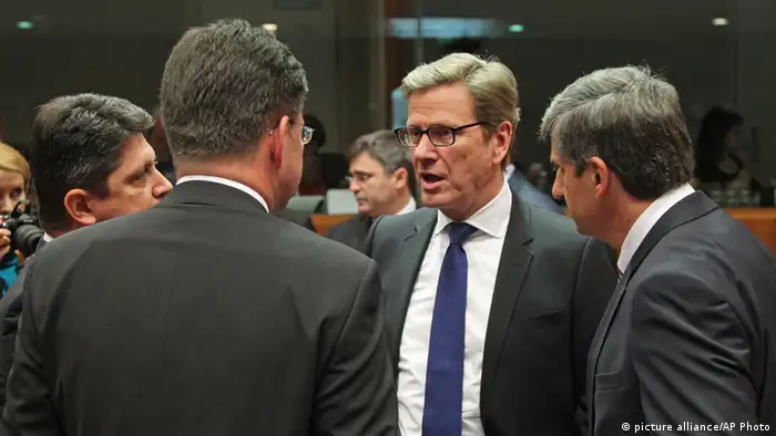 German Foreign Minister Guido Westerwelle, center, listens to Austrian Foreign Minister Michael Spindelegger, right, and other counterparts, during the EU foreign ministers meeting, at the European Council building in Brussels, Monday, May 27, 2013. The European Union nations remain divided on Monday whether to ease sanctions against Syria to allow for weapons shipments to rebels fighting the regime of Syria's President Bashar Assad. (AP Photo/Yves Logghe)