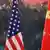 A Chinese man adjusts the Chinese flag before a point press conference by Chinese Foreign Minister Yang Jiechi and US Secretary of State Hillary Clinton at the Great Hall of the People in Beijing on September 5, 2012. Yang said that nations should enjoy freedom of navigation in the South China Sea and promised that there would 'never be issues' in the tense waterway. AFP PHOTO / POOL / Feng Li (Photo credit should read FENG LI/AFP/GettyImages)