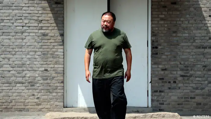 Dissident Chinese artist Ai Weiwei stands at the yard of his studio in Beijing, May 22, 2013. Ai made his first foray into the musical world on Wednesday with the release of the top single from his debut album, a song called Dumbass that takes inspiration from his detention in 2011. The video for the heavy metal song, which was directed by Ai with cinematography by acclaimed filmmaker Christopher Doyle, depicts Ai's 81 days in secretive detention in 2011, which sparked an international outcry. REUTERS/Petar Kujundzic (CHINA - Tags: POLITICS SOCIETY)