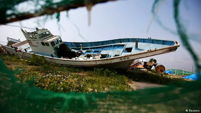 A boat destroyed by the March 11, 2011 tsunami and earthquake lies in Yotsukura port in Iwaki, about 40 km (25 miles) south of the tsunami-crippled Fukushima Daiichi nuclear power plant, Fukushima prefecture May 27, 2013. Commercial fishing has been banned near the tsunami-crippled nuclear complex since the March 2011 tsunami and earthquake. The only fishing that still takes place is for contamination research, and is carried out by small-scale fishermen contracted by the government. Picture taken May 27, 2013. REUTERS/Issei Kato (JAPAN - Tags: DISASTER BUSINESS ENVIRONMENT SOCIETY) ATTENTION EDITORS: PICTURE 10 OF 21 FOR PACKAGE 'TESTING FUKUSHIMA'S FISH' SEARCH 'FUKUSHIMA FISH' FOR ALL IMAGES
