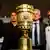 Bayern Munich's coach Jupp Heynckes (2nd R), team captain Phillip Lahm (R), VfB Stuttgart's coach Bruno Labbadia (2nd L) and team captian Serdar Tasci pose next to the German soccer cup (DFB Pokal) trophy during a news conference in Berlin May 31, 2013. Bayern Munich and VfB Stuttgart play the German soccer cup (DFB Pokal) final match on Saturday at the Olympic Stadium in Berlin. REUTERS/Tobias Schwarz (GERMANY - Tags: SPORT SOCCER)