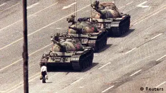 REFILE - CORRECTING BYLINE IN IPTC A man stands in front of a convoy of tanks in the Avenue of Eternal Peace in Beijing in this June 5, 1989 file photo. On June 4, 2013, is the 24th anniversary of a military crackdown on pro-democracy movement in Beijing's Tiananmen Square. REUTERS/Arthur Tsang/Files (CHINA - Tags: POLITICS CIVIL UNREST MILITARY ANNIVERSARY)