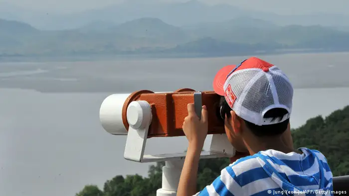 : A visitor looks through binoculars toward North Korea at a South Korean observation post in the border city of Paju near the Demilitarized Zone (DMZ) dividing the two Koreas on June 6, 2013. North and South Korea agreed in principle on June 6 to hold their first official talks for years, signalling a possible breakthrough in cross-border ties after months of escalated military tensions. AFP PHOTO / JUNG YEON-JE (Photo credit should read JUNG YEON-JE/AFP/Getty Images)