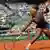 Serena Williams of the U.S. hits a return to Maria Sharapova of Russia during their women's singles final match at the French Open tennis tournament at the Roland Garros stadium in Paris June 8, 2013. REUTERS/Stephane Mahe (FRANCE - Tags: SPORT TENNIS TPX IMAGES OF THE DAY)