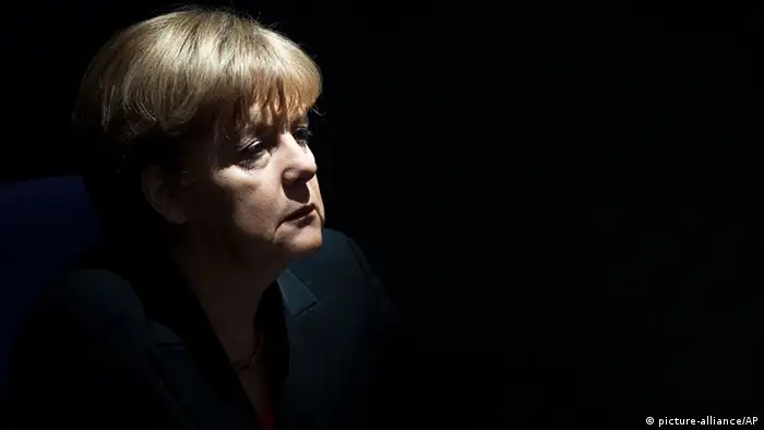 German Chancellor Angela Merkel listens during the speech of German President Joachim Gauck after the oath of office ceremony at the parliament in Berlin, Friday, March 23, 2012. (AP Photo/Markus Schreiber)