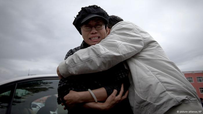 Liu Xia is comforted after her brother was jailed