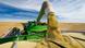 a combine unloads into a grain wagon during the lentil harvest, near Congress, Saskatchewan, Canada a combine unloads into a grain wagon during the lentil harvest, near Congress, Saskatchewan, Canada