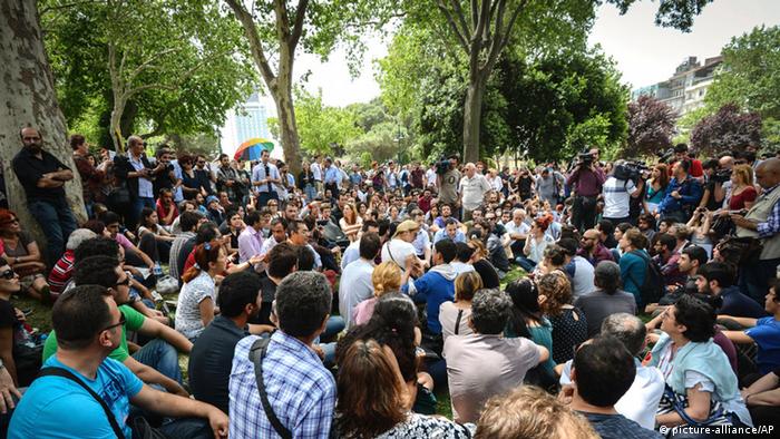 In this Thursday, May 30, 2013, people seen hours before riot police use tear gas and pressurized water to quash a peaceful demonstration by hundreds of people staging a sit-in protest to try and prevent the demolition of trees at an Istanbul park, Turkey. (Photo via AP)