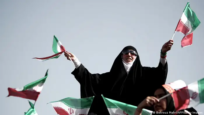 Iranian supporters of top nuclear negotiator and conservative presidential candidate, Saeed Jalili, wave the national flags during his campaign rally at Heydarnia stadium in downtown Tehran on June 12, 2013. Iran's six presidential hopefuls took part in last-ditch election campaigning, hoping to woo the millions of Iranians still undecided between a slew of conservatives and a moderate cleric backed by reformists. AFP PHOTO/BEHROUZ MEHRI (Photo credit should read BEHROUZ MEHRI/AFP/Getty Images)