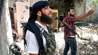 A Free Syrian Army fighter gestures as his comrade looks on in the old city of Aleppo, June 13, 2013. Picture taken June 13, 2013. REUTERS/Jalal al-Halabi/Shaam News Network/Handout (SYRIA - Tags: CONFLICT) ATTENTION EDITORS - THIS PICTURE WAS PROVIDED BY A THIRD PARTY. REUTERS IS UNABLE TO INDEPENDENTLY VERIFY THE AUTHENTICITY, CONTENT, LOCATION OR DATE OF THIS IMAGE. FOR EDITORIAL USE ONLY. NOT FOR SALE FOR MARKETING OR ADVERTISING CAMPAIGNS. NO SALES. NO ARCHIVES. THIS PICTURE IS DISTRIBUTED EXACTLY AS RECEIVED BY REUTERS, AS A SERVICE TO CLIENTS