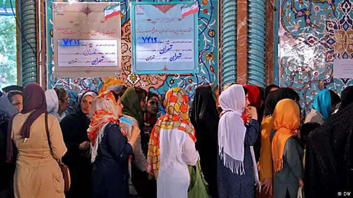 Women line up to vote at a polling place in Iran, June 2014.