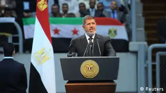 Egypt's President Mohamed Mursi delivers a speech at a Syria solidarity conference organised by the Muslim Brotherhood, in Cairo, in this handout picture taken June 15, 2013, and provided by the Egyptian Presidency. Mursi said he had cut all diplomatic ties with Damascus on Saturday and demanded Hezbollah leave Syria, pitching the most populous Arab state more firmly against Syrian President Bashar al-Assad. REUTERS/Egyptian Presidency/Handout (EGYPT - Tags: POLITICS TPX IMAGES OF THE DAY) ATTENTION EDITORS – THIS IMAGE WAS PROVIDED BY A THIRD PARTY. NO SALES. NO ARCHIVES. FOR EDITORIAL USE ONLY. NOT FOR SALE FOR MARKETING OR ADVERTISING CAMPAIGNS. THIS PICTURE IS DISTRIBUTED EXACTLY AS RECEIVED BY REUTERS, AS A SERVICE TO CLIENTS