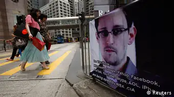 A poster supporting Edward Snowden, a former contractor at the National Security Agency (NSA) who leaked revelations of U.S. electronic surveillance, is displayed at Hong Kong's financial Central district June 17, 2013. Snowden reportedly flew to Hong Kong on May 20. He checked out of a luxury hotel on June 10 and his whereabouts remain unknown. Snowden has said he intends to stay in Hong Kong to fight any potential U.S. moves to extradite him. REUTERS/Bobby Yip (CHINA - Tags: POLITICS CRIME LAW SCIENCE TECHNOLOGY)