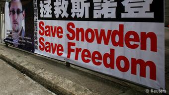A poster supporting Edward Snowden, a former contractor at the National Security Agency (NSA) who leaked revelations of U.S. electronic surveillance, is displayed at Hong Kong's financial central district June 17, 2013. Snowden reportedly flew to Hong Kong on May 20. He checked out of a luxury hotel on June 10 and his whereabouts remain unknown. Snowden has said he intends to stay in Hong Kong to fight any potential U.S. moves to extradite him. REUTERS/Bobby Yip (CHINA - Tags: POLITICS CRIME LAW SCIENCE TECHNOLOGY)