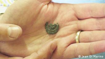 A close up of a Pilgrim badge on someone's hand, found by mudlarker on Thames foreshore 'Part of The British Museum’s pilgrim badge display' (Photos:Jean Di Marino for DW)