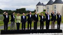 G8 and EU leaders (L-R) European Commission President Jose Manuel Barroso, Japan's Prime Minister Shinzo Abe, Germany's Chancellor Angela Merkel, Russia's President Vladimir Putin, Britain's Prime Minister David Cameron, US President Barack Obama, France's President Francois Hollande, Canada's Prime Minister Stephen Harper, Italy's Prime Minister Enrico Letta and European Council President Herman Van Rompuy wave during the family photograph on the second day of the G8 summit at the Lough Erne resort near Enniskillen in Northern Ireland on June 18, 2013. Russia and the US agreed at the G8 summit to push for Syria peace talks, but Presidents Vladimir Putin and Barack Obama made clear their deep differences over the conflict. AFP PHOTO / POOL / JEWEL SAMAD (Photo credit should read JEWEL SAMAD/AFP/Getty Images)