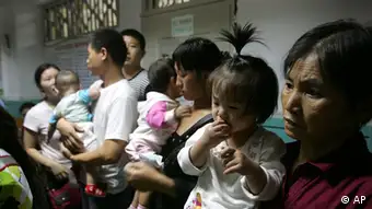 Chinese parents and their children wait for ultrasound exams at Children's Hospital in Chengdu, China's southwest Sichuan province, Wednesday, Sept. 17, 2008. Chinese police arrested 12 more people Thursday as a fourth death was reported in a scandal involving tainted milk powder that has sickened more than 6,200 babies. (AP Photo/Color China Photo) ** CHINA OUT **