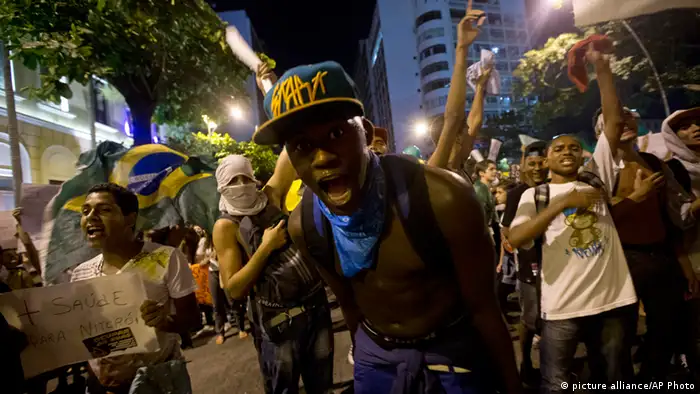 Demonstrators shout slogans during an anti-government protest in Rio de Janeiro's sister city, Niteroi, Brazil, Wednesday evening, June 19, 2013. Rio de Janeiro and Sao Paulo city leaders said Wednesday that they reversed an increase in bus and subway fares that ignited anti-government protests. Many people doubted the move would quiet the demonstrations which have moved well beyond outrage over the fare hikes into communal cries against poor public services. (AP Photo/Silvia Izquierdo) pixel