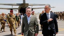 German Defence Minister Thomas de Maiziere (L) speaks with his Italian counterpart Mario Mauro on the tarmac upon their arrival at Herat airfield June 20, 2013. REUTERS/Fabrizio Bensch (AFGHANISTAN - Tags: POLITICS MILITARY)