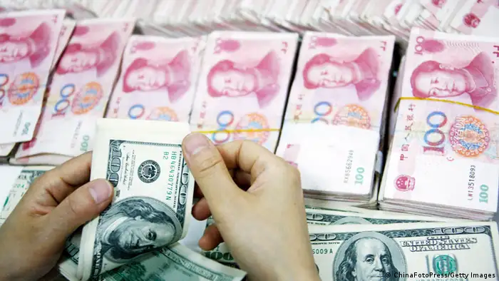 HUAIBEI, CHINA - JULY 26: (CHINA OUT) An employee counts money at a branch of Industrial and Commercial Bank of China Limited (ICBC) on July 26, 2011 in Huaibei, Anhui Province of China. According to the China Foreign Exchange Trading System, The Chinese currency, Renminbi (RMB), Tuesday rose 33 basis points from previous trading day to a record high of 6.4470 against the U.S. dollar. (Photo by ChinaFotoPress/Getty Images)