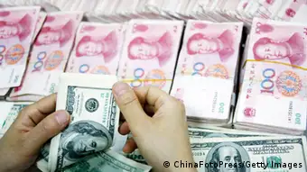 HUAIBEI, CHINA - JULY 26: (CHINA OUT) An employee counts money at a branch of Industrial and Commercial Bank of China Limited (ICBC) on July 26, 2011 in Huaibei, Anhui Province of China. According to the China Foreign Exchange Trading System, The Chinese currency, Renminbi (RMB), Tuesday rose 33 basis points from previous trading day to a record high of 6.4470 against the U.S. dollar. (Photo by ChinaFotoPress/Getty Images)