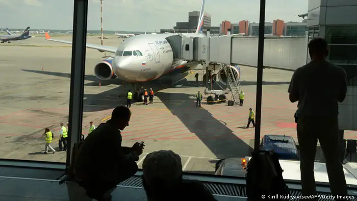 People look the passenger plane, flight SU 150 to Havana, docking to a boarding bridge at the Moscow Sheremetyevo airport on June 24, 2013. US intelligence leaker Edward Snowden was set to fly out of Russia today by flight SU 150 to Havana to seek asylum in Ecuador, as Washington demanded Moscow hand over the fugitive to face espionage charges at home. AFP PHOTO / KIRILL KUDRYAVTSEV (Photo credit should read KIRILL KUDRYAVTSEV/AFP/Getty Images)
