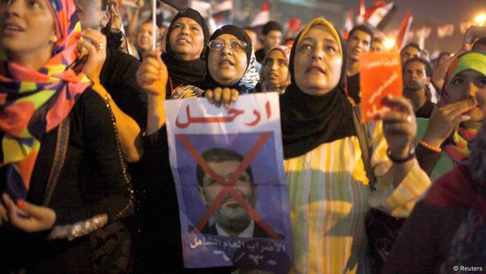 A protester holds a crossed out picture of the president while chanting anti-Mursi and anti-Muslim Brotherhood slogans as they wait in Tahrir square ahead of President Mohamed Mursi's public address, in Cairo June 26, 2013. REUTERS/Asmaa Waguih (EGYPT - Tags: POLITICS CIVIL UNREST)