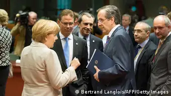 German Chancellor Angela Merkel (L) chats with Greek Prime Minister Antonis Samaras (R) and Dutch Prime Minister Mark Rutte (C) prior to a roundtable meeting at the EU headquarters on June 7, 2013 in Brussels, during European Union leaders summit. European Commission President Jose Manuel Barroso on Thursday announced a political deal on the EU's hotly contested 2014-2020 trillion-euro budget, hours before an EU summit mulls how to get millions of jobless youths back into the workplace. AFP PHOTO / BERTRAND LANGLOIS (Photo credit should read BERTRAND LANGLOIS/AFP/Getty Images)