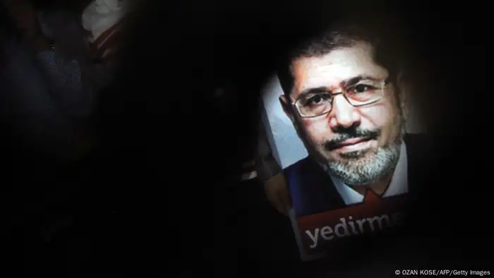 A poster of Egypt's President Mohammed Morsi is seen during a pro-Morsi demonstration on July 1, 2013 in Istanbul. The Egyptian armed forces have piled pressure on Islamist President Mohamed Morsi, to applause from the opposition who want his resignation, but analysts say their intervention may be fraught with difficulties. AFP PHOTO/OZAN KOSE (Photo credit should read OZAN KOSE/AFP/Getty Images)