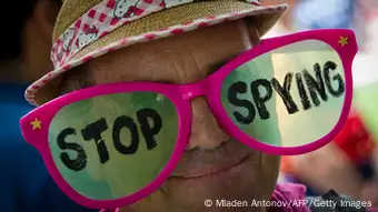  A human rights activists wears pink glasses reading 'stop spying'
