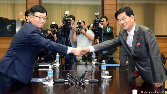 Suh Ho, the head of South Korea's working-level delegation, left, shakes hands with his North Korean counterpart Park Chol Su during their meeting at Tongilgak in North Korean side of Panmunjom which has separated the two Koreas since the Korean War, Saturday, July 6, 2013. Delegates from North and South Korea began talks Saturday on restarting a stalled joint factory park that had been a symbol of cooperation between the bitter rivals. (AP Photo/Korea Pool via Yonhap) KOREA OUT pixel