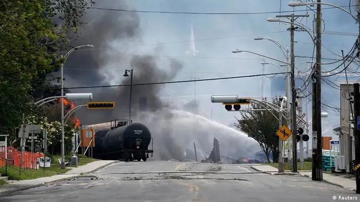 A burning train wagon is seen after an explosion at Lac Megantic, Quebec, July 6, 2013. Several people were missing after four tank cars of petroleum products exploded in the middle of a small town in the Canadian province of Quebec early on Saturday in a fiery blast that destroyed dozens of buildings. REUTERS/Mathieu Belanger (CANADA - Tags: DISASTER SOCIETY)