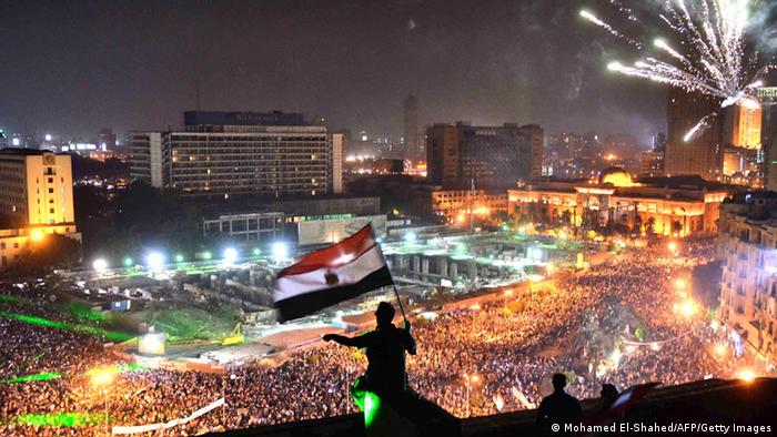 Egyptians wave the national flag AFP PHOTO / MOHAMED EL-SHAHED (Photo credit should read MOHAMED EL-SHAHED/AFP/Getty Images)