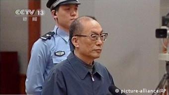 In this image made from China Central Television video, former Chinese Railways Minister Liu Zhijun attends his sentencing at a courtroom at Beijing No. 2 Intermediate People's Court in Beijing Monday, July 8, 2013. The official Xinhua News Agency said Liu was sentenced to death with a two-year reprieve by a court in Beijing on Monday. Such sentences usually are commuted to life in prison with good behavior. Liu, 60, who oversaw the ministry's high-profile bullet train development, was accused of taking massive bribes and steering lucrative projects to associates. Chinese characters at bottom reads Former Railway Minister Liu Zhijun sentencing, Taking bribes and abuse of power sentenced to suspended death sentence. (AP Photo/CCTV via AP Video) CHINA OUT, TV OUT pixel